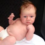 Picture of clients baby propped up against a chair